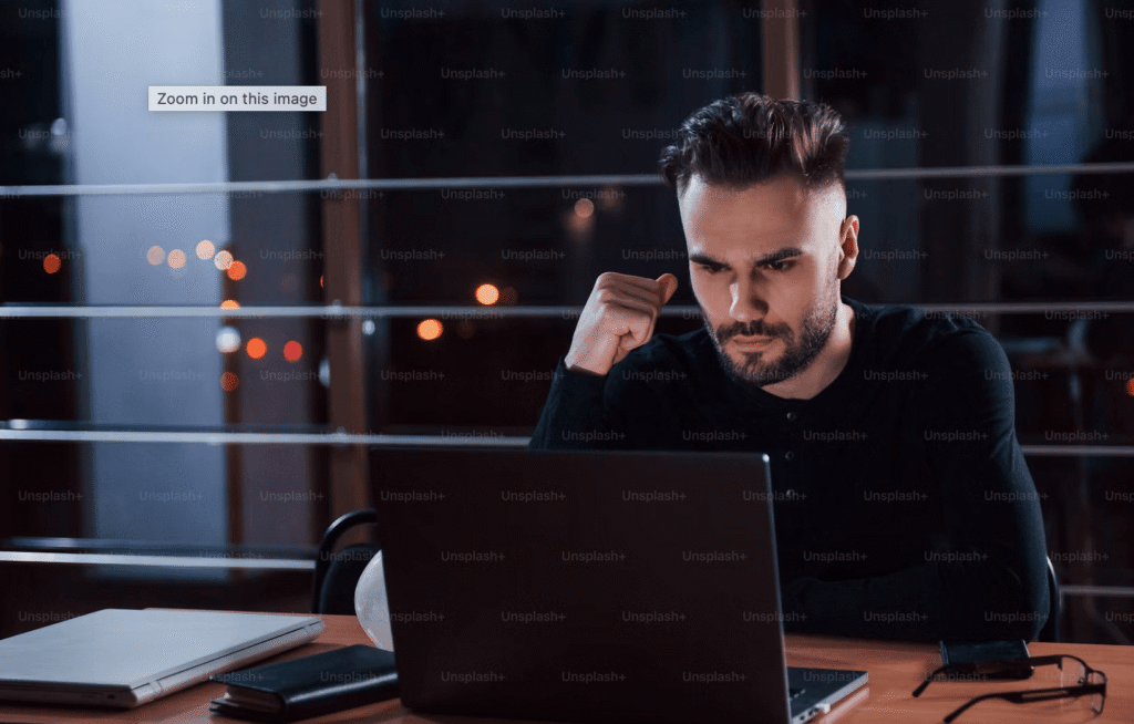man looking distracted at laptop