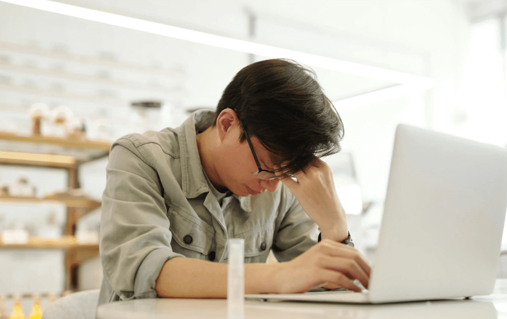 man looking restless at desk