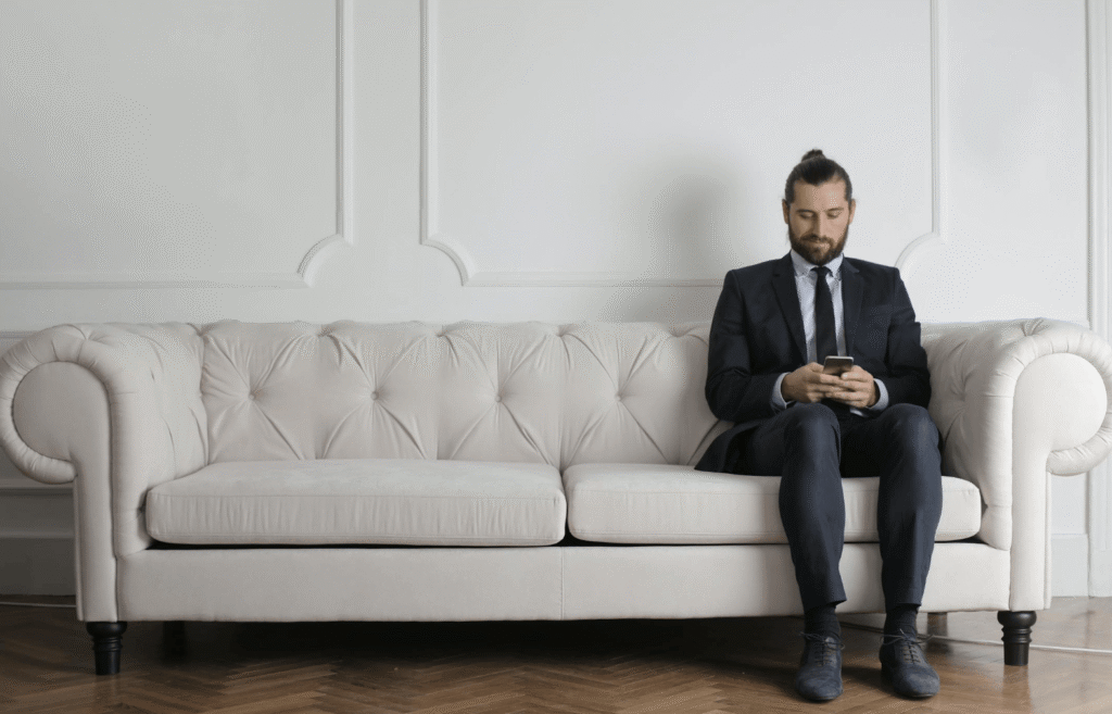 man sitting calmly with phone minimal space 