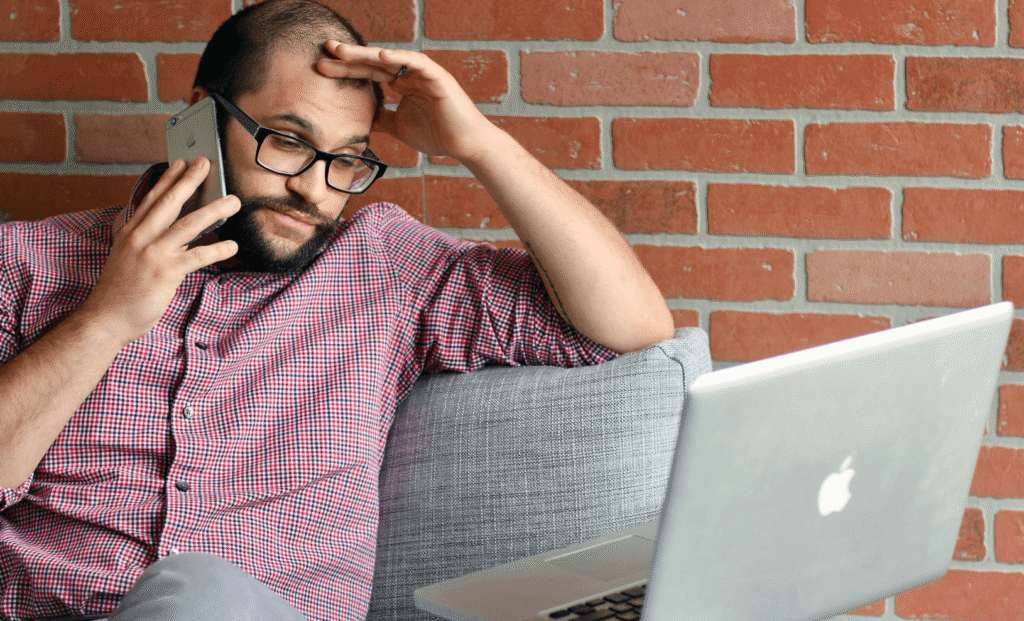 man switching tabs laptop distracted