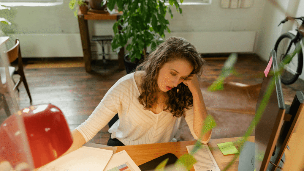woman sitting tired desk monday morning