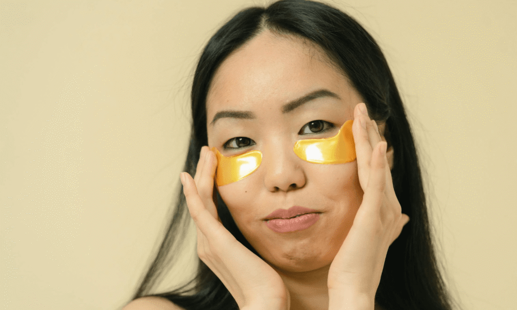 woman touching under eyes tired look